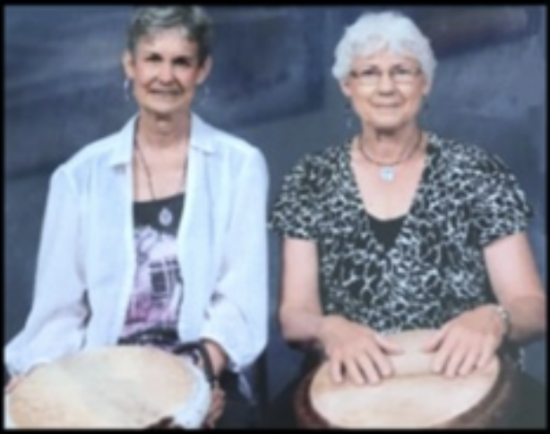 image of two people, with drums. 
